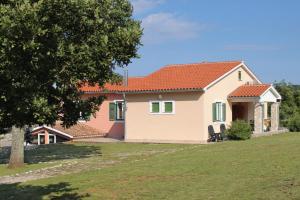 a house with a green and pink roof at Secluded family friendly house Kapelica, Labin - 5536 in Raša