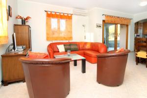 a living room with a couch and a table at Secluded family friendly house Kapelica, Labin - 5536 in Raša