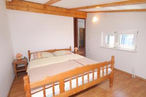 a bedroom with a large bed in a room at Apartments and rooms with WiFi Senj - 5560 in Senj