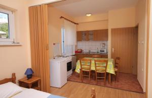 a kitchen with a table and chairs in a room at Apartments and rooms with WiFi Senj - 5560 in Senj