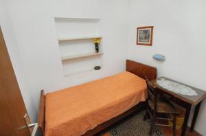 a small bedroom with a bed and a table at Apartments with a parking space Bol, Brac - 5605 in Bol