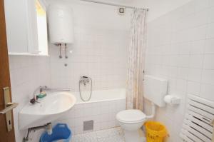 a bathroom with a toilet and a sink at Apartments with a parking space Bol, Brac - 5605 in Bol