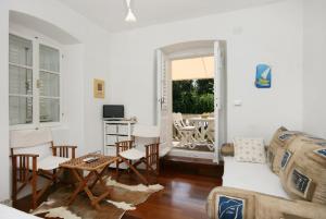 a living room with a couch and a table at Apartments by the sea Punat, Krk - 5564 in Punat