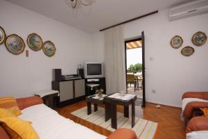 a living room with two couches and a tv at Apartments by the sea Sumartin, Brac - 5619 in Sumartin