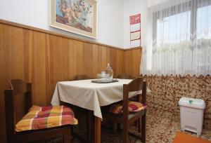 a dining room with a table and chairs and a window at Apartments by the sea Sumartin, Brac - 5619 in Sumartin