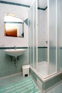 a bathroom with a sink and a shower at Apartments by the sea Selce, Crikvenica - 5550 in Selce