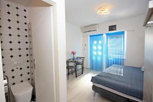 a small bedroom with a bed and a table at Apartments with WiFi Supetar, Brac - 5665 in Supetar