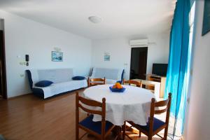 a living room with a table and a couch at Apartments with parking space Crikvenica - 5553 in Crikvenica