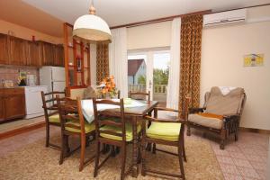 a kitchen and dining room with a table and chairs at Apartments with a parking space Postira, Brac - 5618 in Postira