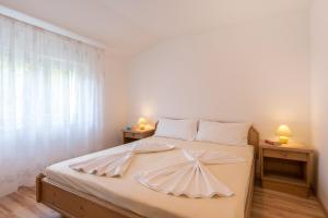 a bedroom with a large bed with two night stands at Apartment Dramalj 5592b in Dramalj