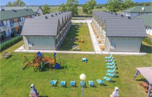 an aerial view of a row of buildings with chairs and tables at Cozy Home In Grzybowo With Kitchen in Grzybowo