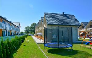 a gazebo in the yard of a house at Cozy Home In Grzybowo With Kitchen in Grzybowo