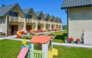 a resort with a playground and a play area at Cozy Home In Grzybowo With Kitchen in Grzybowo