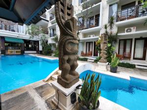 a hotel with a swimming pool in front of a building at Baleka Resort & Spa in Legian