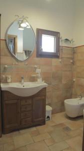 a bathroom with a sink and a mirror and a tub at Casa Stefano Lecce in Lecce
