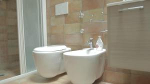 a bathroom with a toilet and a sink and a shower at Casa Stefano Lecce in Lecce