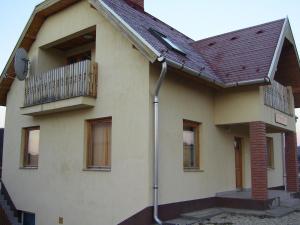 a house with a balcony and a balcony at Szigeti B&B in Bogács