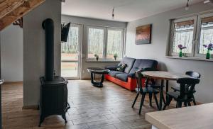 a living room with a couch and a wood stove at Kaszubska Zagroda in Lipuska Huta