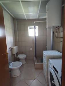 a small bathroom with a toilet and a sink at Guesthouse Branko in Bar