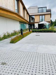 a building with a brick driveway in front of it at Hotel Bell-X Kortrijk-Wevelgem in Wevelgem