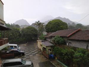 a car parked in a parking lot next to houses at HOTEL KANA KALIURANG in Sleman