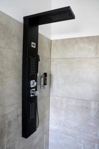 a shower with a black control panel in a bathroom at Sporthotel Dorum in Dorum +19 photos