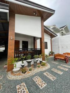 a courtyard with a building with a pavilion with plants at Tagaytay Transient House, 4 bedrooms, billiard in Indang