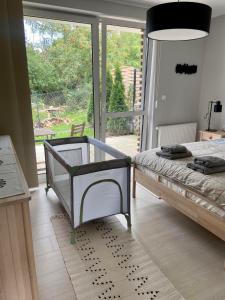 a bedroom with a bed and a large window at Apartamenty Olimpijska 1B & 1T in Szczyrk