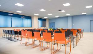 a conference room with orange and black chairs at ibis Styles Toulon Centre Port in Toulon