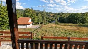 a view from a window of a house with a fence at Green Eco Cottage in Kolašin