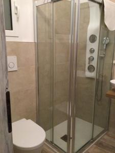 a shower stall with a toilet in a bathroom at 6alcentrale in Bellagio