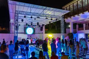 a crowd of people standing around a stage at night at AQI Hydros Club in Kemer