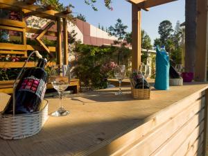 a wooden table with wine glasses and wine bottles at AQI Hydros Club in Kemer