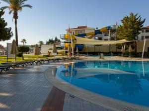 a pool at a resort with a slide at AQI Hydros Club in Kemer