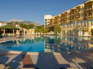 a large swimming pool in front of a building at AQI Hydros Club in Kemer