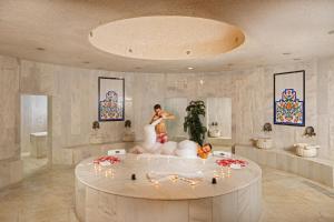 a bride and groom in a bath tub in a room at AQI Hydros Club in Kemer