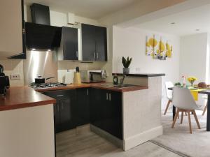 a kitchen with a sink and a stove top oven at Benjamin Gardens Holiday Home in Great Driffield