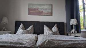 a bedroom with a bed with white sheets and pillows at Meiers FeWo in Tremmen