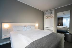 ein Schlafzimmer mit einem großen weißen Bett in einem Zimmer in der Unterkunft BIG MAMA Berlin in Berlin