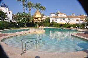 a large swimming pool with a gazebo at Costahispania 308 in Gran Alacant