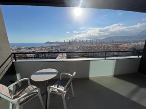 a balcony with a table and chairs and a view at Hotel Primavera Park in Benidorm