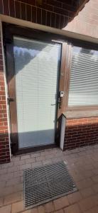 een glazen deur naar een gebouw met een raam bij Elite Flats Two bedroom in Utena