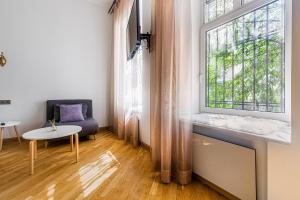 a living room with a couch and a large window at KayKay Apartments in Odesa