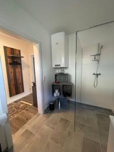 a bathroom with a shower and a glass door at Sorinas Unterkunft WB16 Top 6 