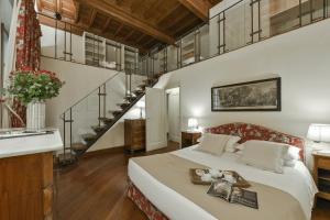 A bed or beds in a room at Raffaello apartment with fireplace in Oltrarno