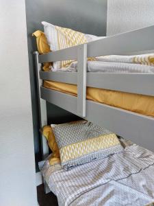 a couple of bunk beds with pillows on them at Lovely 2 bedroomed flat in the centre of Longton in Longton