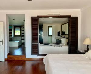 a bedroom with a large bathroom with a large mirror at Luxury Villa with Pool in Marbella