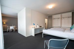 a bedroom with a bed and a table and chairs at BIG MAMA Berlin in Berlin