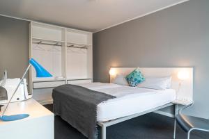 柏林BIG MAMA Berlin的一间卧室，配有一张床和一张带电脑的书桌