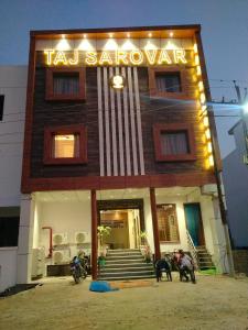 a taj sarmaarma restaurant with two dogs in front of it at Hotel Taj Sarovar By WB Inn in Agra
